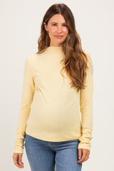 woman wearing a yellow striped maternity top with long sleeves and a relaxed fit, showing her baby bump