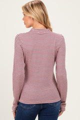 woman wearing a burgundy and cream striped maternity top, viewed from the back with fitted long sleeves