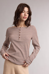woman wearing a brown and beige striped long sleeve henley top with button details