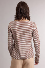 woman wearing a brown and cream striped long sleeve top, showing the back view