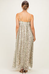 woman wearing a light floral print maternity maxi dress with spaghetti straps, showing the back view