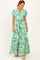 woman wearing a green floral maxi dress with short sleeves and a belted waist