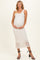 woman wearing a white lace maternity dress, styled with a fitted silhouette, holding her baby bump