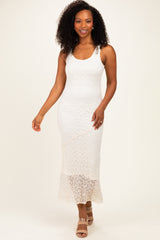woman wearing a white lace maxi dress with a fitted silhouette and spaghetti straps