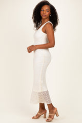 woman wearing a white lace midi dress with a fitted silhouette and a flared hem, paired with nude block-heeled sandals