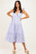 woman wearing a lavender tiered maxi dress with adjustable tie straps and a v-neckline, posing with hands on hips