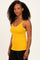 woman wearing a mustard yellow ribbed tank top with lace trim and black leggings
