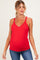 woman wearing a red maternity tank top with lace trim and showing her baby bump while posing