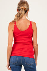 woman wearing a red maternity tank top with lace trim and back view, paired with blue jeans