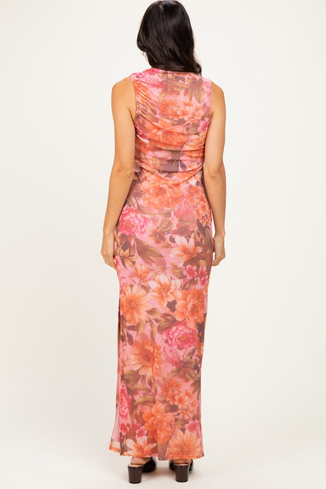 woman wearing a fitted floral maxi dress with a scoop back and side slit, shown from the back