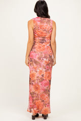 woman wearing a fitted floral maxi dress with a scoop back and side slit, shown from the back