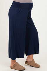 woman wearing navy blue maternity wide-leg pants with a stretchy waistband and stylish slip-on shoes