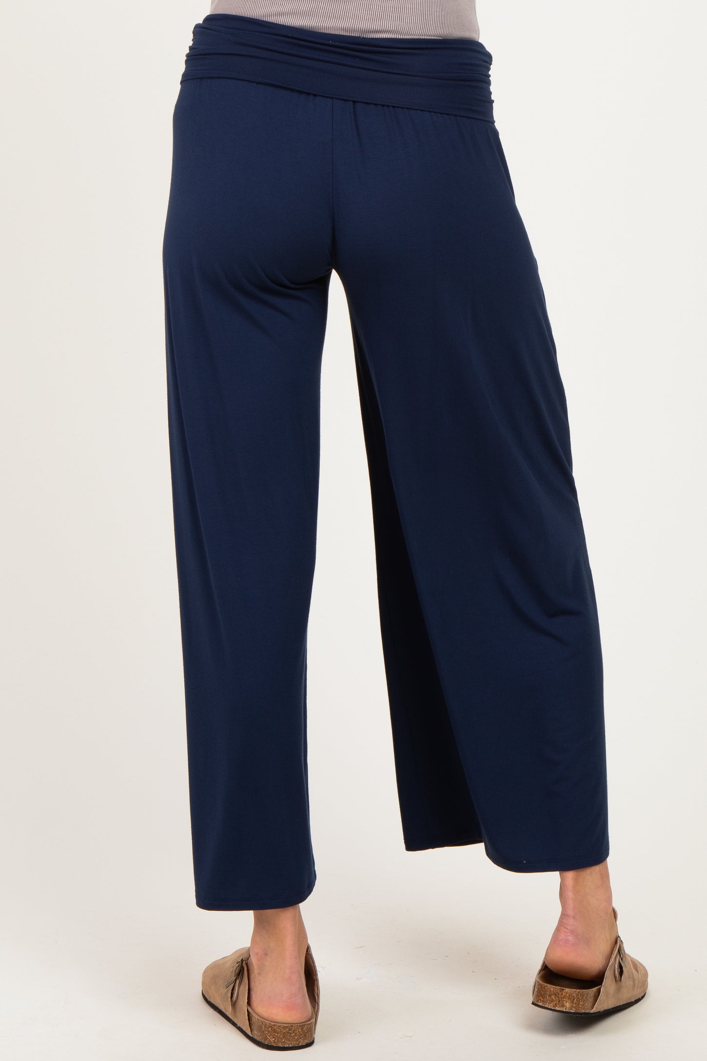 woman wearing navy blue wide-leg maternity pants, showing the back view with an elastic waistband