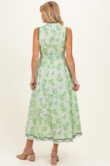 woman wearing a green floral maternity maxi dress, showing the back view and a flowy silhouette