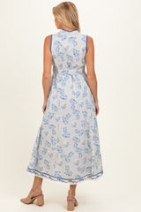 woman wearing a blue and white floral maternity maxi dress, showing the back view