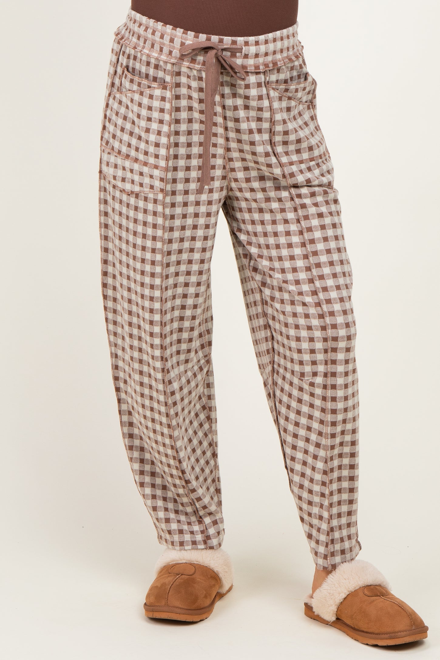 woman wearing brown and white checked maternity pants with a drawstring and side pockets