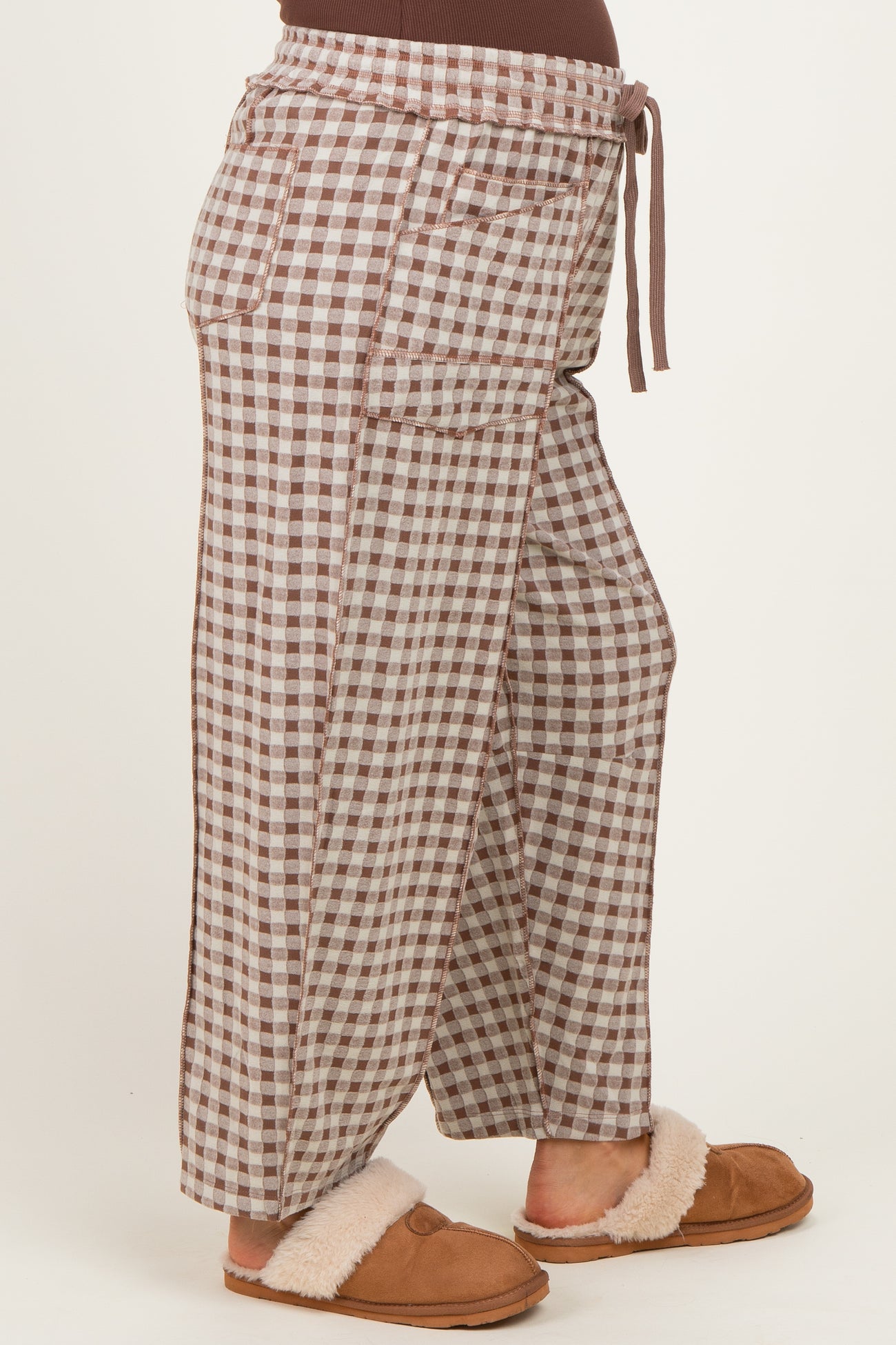 woman wearing brown and cream checkered maternity wide-leg pants with drawstring waist and side pockets