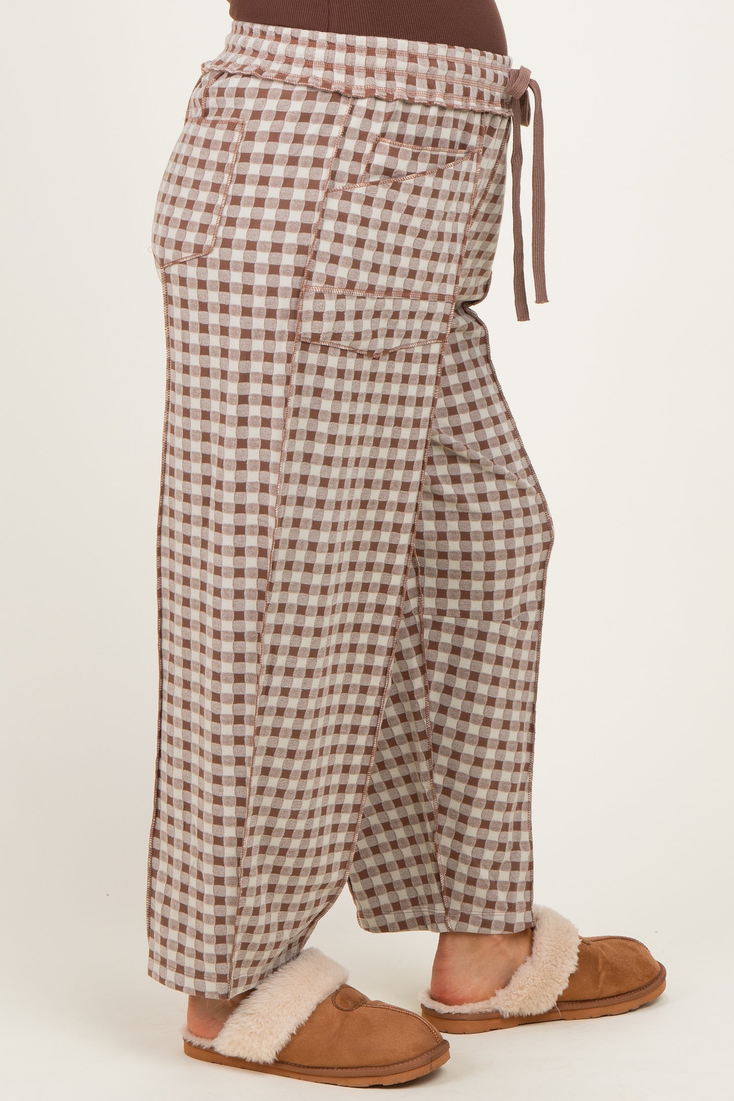 woman wearing brown and cream checkered maternity wide-leg pants with drawstring waist and side pockets