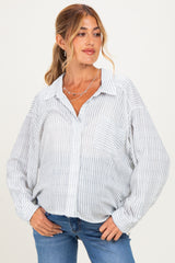 woman wearing a white and blue striped maternity button-up shirt with a front pocket and relaxed fit