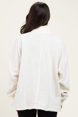 woman wearing a relaxed fit white sweatshirt with a back seam detail and long sleeves
