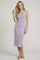 woman wearing a light purple ribbed midi dress with button details and a fitted silhouette