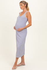 woman wearing a light purple maternity dress with adjustable straps and a visible baby bump