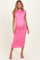 woman wearing a bright pink lace maternity dress with short sleeves and a fitted silhouette, showcasing her baby bump