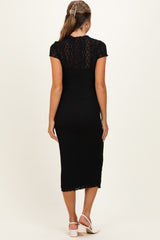 woman wearing a black maternity dress with short sleeves and a fitted silhouette, showing a stylish lace design from the back