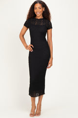 woman wearing a black lace midi dress with short sleeves and a fitted silhouette