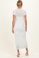 woman wearing a white lace maternity dress with a fitted silhouette and short sleeves, seen from the back