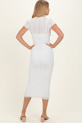 woman wearing a white lace midi dress with short sleeves, showing the back view and fitted silhouette