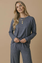 woman wearing a navy blue and white striped long sleeve top with a relaxed fit and matching wide-leg pants