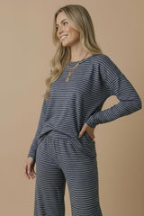 woman wearing a navy blue and white striped long sleeve top paired with matching wide-leg pants