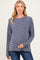 woman wearing a navy and white striped maternity top and showing her baby bump