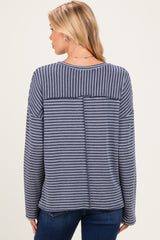 woman wearing a navy and white striped maternity top with a relaxed fit and back seam detail
