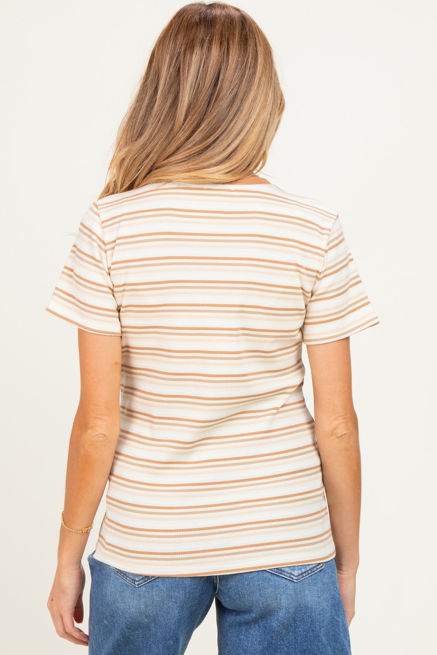 woman wearing a striped maternity top with short sleeves, showing the back view