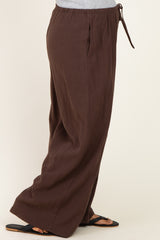 woman wearing brown maternity wide-leg pants with an elastic waistband and tie detail