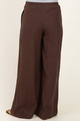 maternity wear brown wide leg pants with an elastic waistband and side pockets, shown from the back