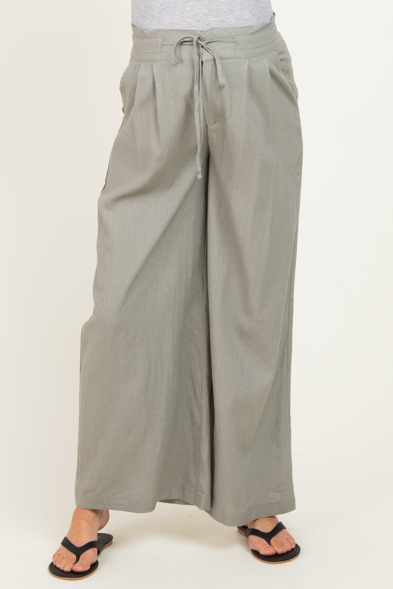 woman wearing light grey wide-leg maternity pants with an elastic waistband and drawstring detail