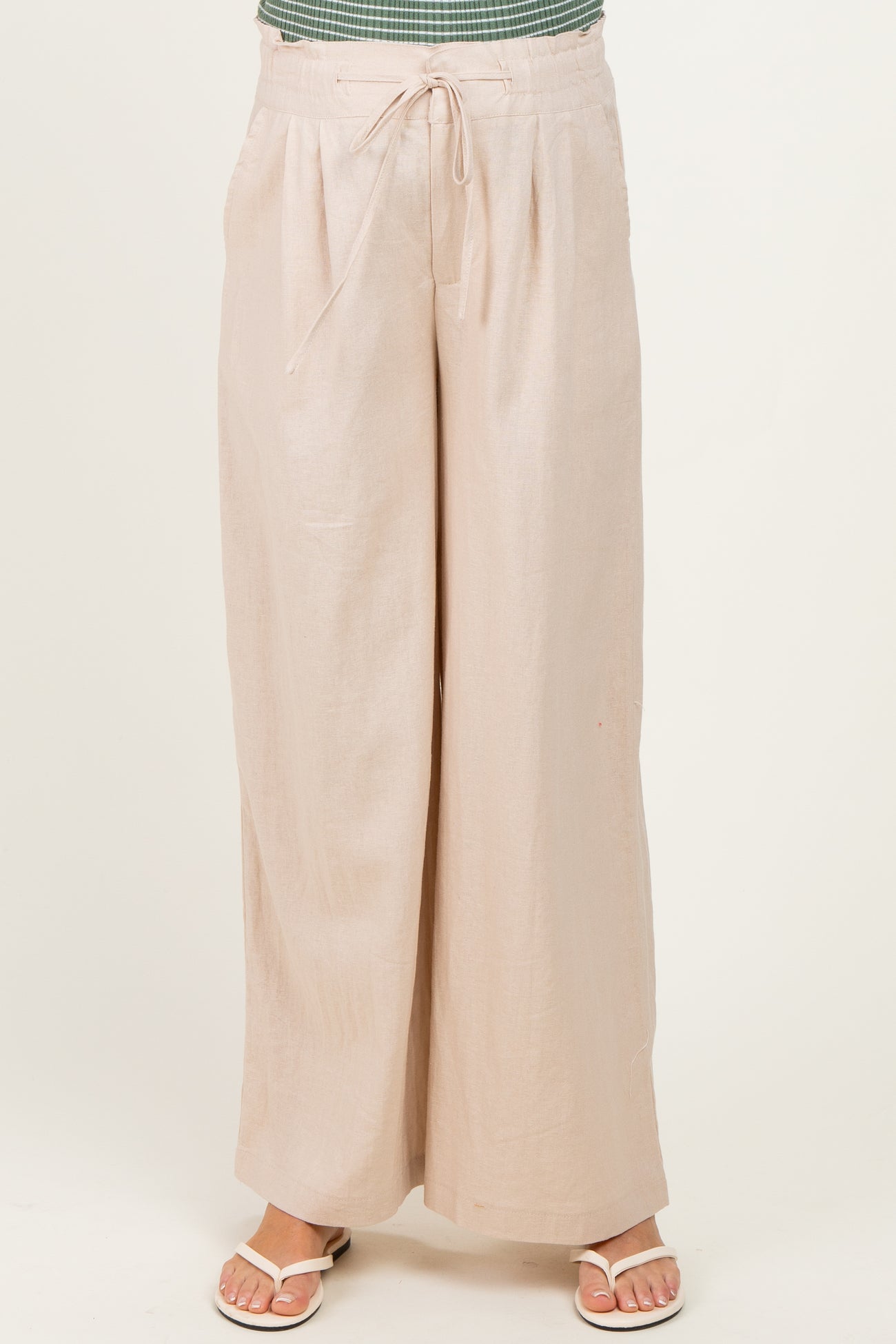 woman wearing light beige maternity wide-leg pants with tie waist detail