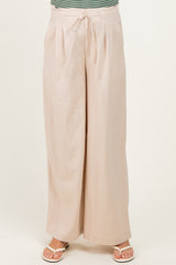 woman wearing light beige maternity wide-leg pants with tie waist detail