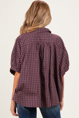 woman wearing a maroon checkered maternity shirt with a relaxed fit and back pleat detail