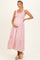 woman wearing a light pink striped maternity maxi dress with smocked bodice and ruffled hem, showing her baby bump
