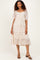 woman wearing a white floral tiered midi dress with puff sleeves and a ruffled hem