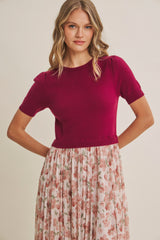 woman wearing a fuchsia short sleeve sweater styled with a floral maxi skirt
