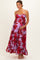 woman wearing a lavender floral maternity maxi dress with spaghetti straps and holding her baby bump