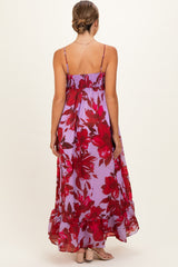 woman wearing a purple floral maternity maxi dress with adjustable straps and a flowing skirt
