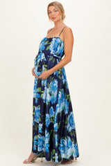 woman wearing a navy floral maternity maxi dress with a tie detail and a visible baby bump