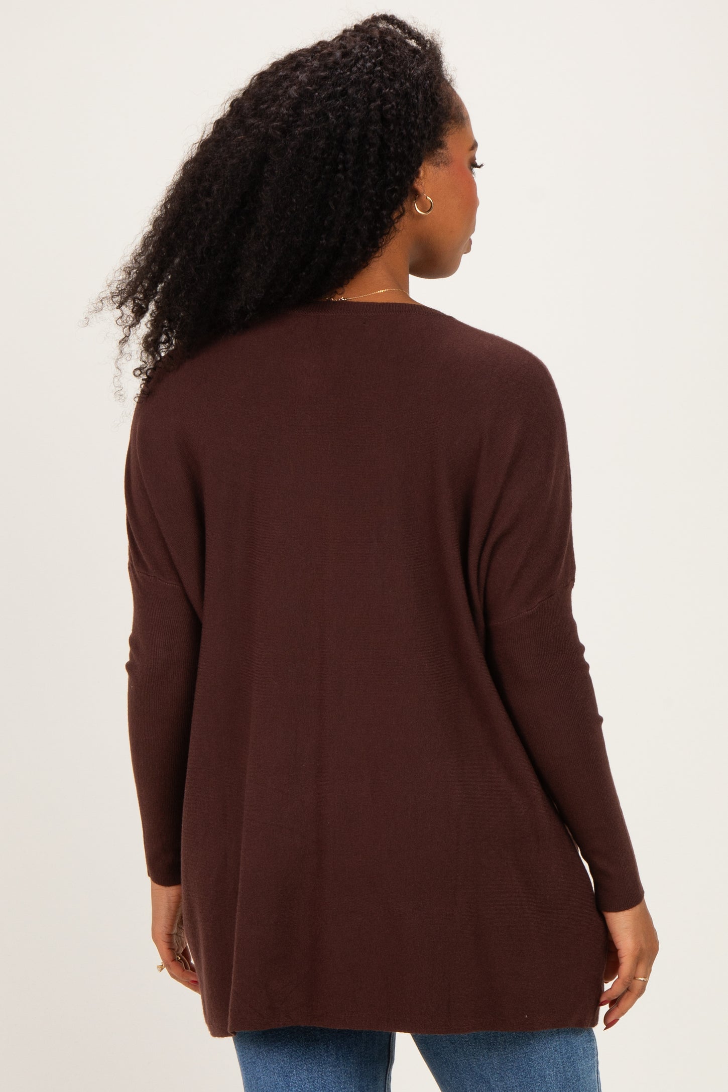 woman wearing a dark brown long sleeve cardigan, viewed from the back, with a relaxed fit and ribbed details