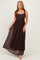 woman wearing a brown lace maxi dress with tie shoulder straps and a flowy skirt